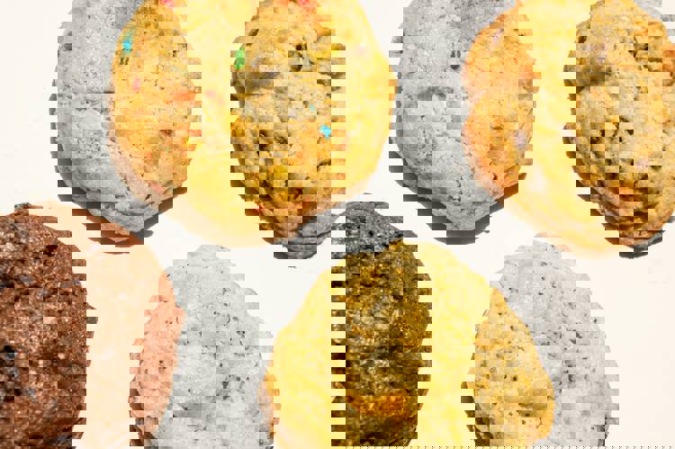 four different types of cookies are on a white surface