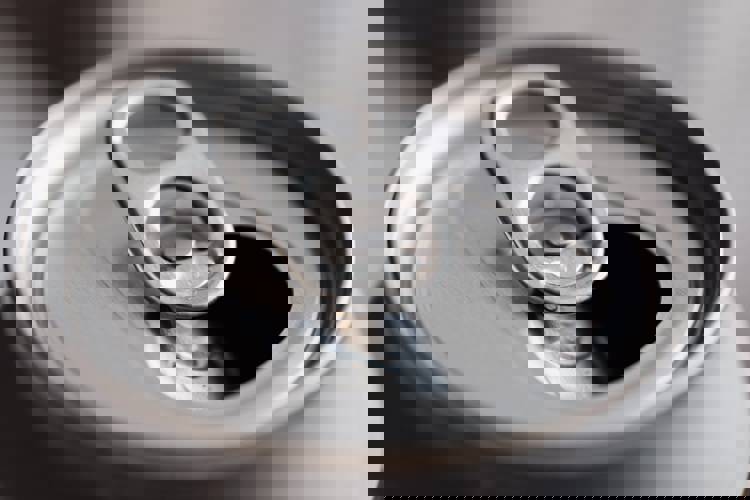 a close up of an open soda can on a table